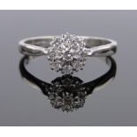 An 18ct white gold diamond cluster ring, setting 8mm across, size Q.