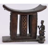 An Ashanti tribal carved wood stool, seat length 50cm and an African carved wood figure,