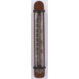 A mahogany cased wall hanging thermometer, early 20th century with magnifying glass panel front,