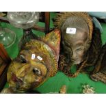 2 Carved and painted Eastern wooden masks.