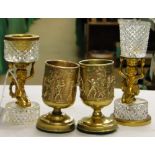 A pair of embossed gilt brass vases, and 2 crystal and brass figure vessels.