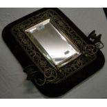 A brass Girandole mirror mounted on velvet panel.