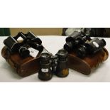 2 Leather cased binoculars, and another with inset compass.