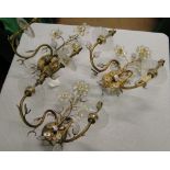 A set of 3 gilt metal and glass wall lights with flowerhead designs.