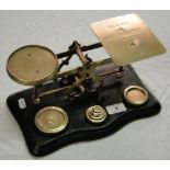 A set of Victorian brass letter scales engraved with postage rates, and complete with weights.