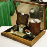 A table top display case containing a carriage clock, boot design pin cushion, a desk bell, etc.