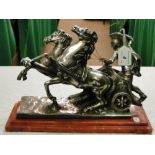 A silver plated sculpture of a charioteer, signed, A Santini, on base.