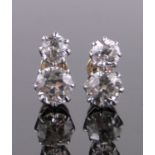 A pair of 2-stone diamond earrings, total diamond content approx.