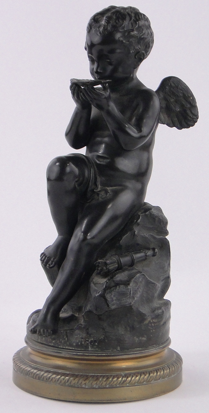 A 19th century patinated bronze sculpture of Eros drinking from a scallop shell, unsigned,