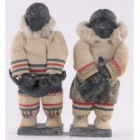 Pair of Inuit carved stone standing figures, circa 1950s with cloth bodies, height 28cm.