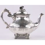 A 19th century continental white metal teapot on cast foot, indistinct continental marks, 24.8 oz.