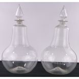 2 Similar large 19th century glass chemist's jars with facet-cut glass stoppers,