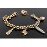 A rolled gold charm bracelet mounted with various gold charms.