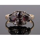 A Victorian garnet and pearl cluster ring, unmarked gold settings, size P.