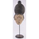 An African carved and painted wood tribal mask, height 35cm on stand.