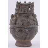 A Chinese treacle glaze terracotta temple ornament, relief decorated figures and arches,