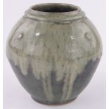 A Studio Pottery vase of bulbous form, green slip glaze with impressed studio marks T C,