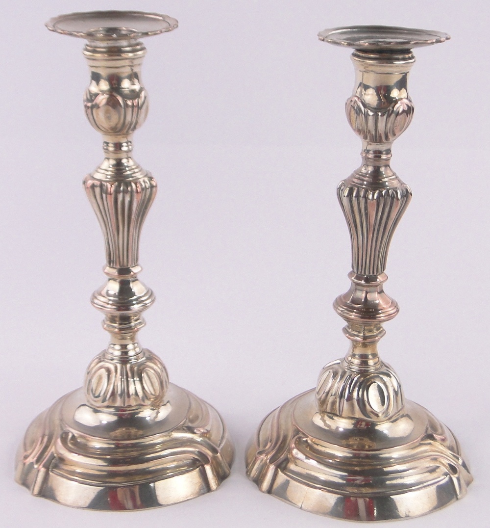Pair of French 18th century silver plate on copper candlesticks, height 25cm.