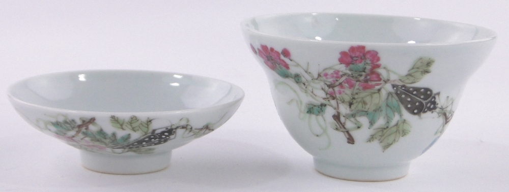 A Chinese porcelain tea bowl and cover, hand painted flowers and beetle with text, diameter 10cm.