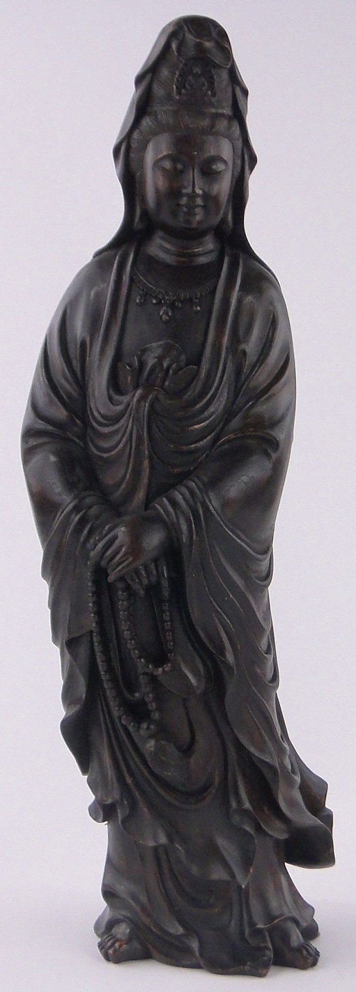 A Chinese carved and stained wood figure of Guanyin, height 60cm.