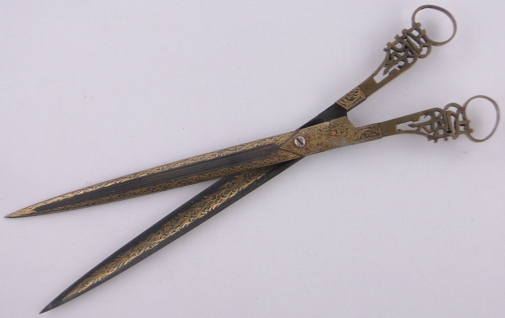 A pair of Turkish gold inlaid calligraphy scissors, with pierced brass handles, length 27.5cm.