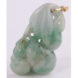 A Chinese carved jade pendant in the form of exotic fruit, unmarked high carat gold loop mount,