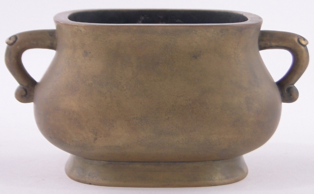 A Chinese bronze 2-handled censer, of bulbous rectangular form, impressed seal mark under,