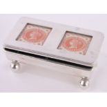 An Edwardian silver stamp box, double glass panelled lid on ball feet, Birmingham 1911, length 6cm.