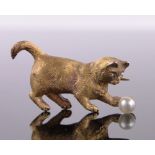 An 18ct gold pearl and diamond brooch in the form of a cat playing with a ball, circa 1900, 6g,