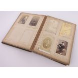 A Victorian photograph album, containing family portraits and carte visite.