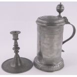 A German pewter lidded tankard, height 20cm and a German pewter candlestick, (2).