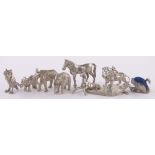 A group of miniature unmarked white metal animals.