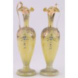 Pair of Bohemian yellow marble glass ewers, painted and gilded floral decoration, height 30cm.