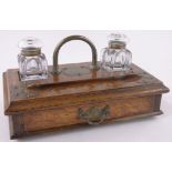 A Victorian oak desk stand, with original moulded glass inkwells, plated mounts and drawer below,