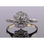 An 18ct gold and platinum diamond cluster ring, total diamond content approx. 0.