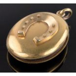 A Victorian unmarked gold locket, with horseshoe mount and monogram, height excluding bale 35mm,