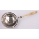 An early 19th century French silver tea/lemon strainer, with turned ivory handle, length 20cm.