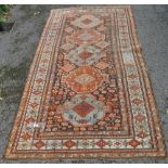 Antique red ground Afghan rug with 5 symmetrical borders and centre lozenge panel,