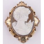 A carved Cameo brooch, in ornate scrolled 9ct gold frame, height 70mm.