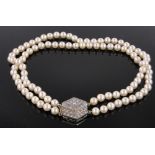 An Art Deco double row pearl collar, with stepped unmarked gold diamond set clasp,