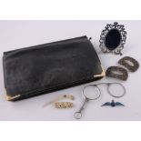 A Mappin & Webb leather bag with 9ct gold mounts, a continental pierced silver photo frame,