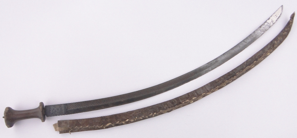 An Ethiopian curved sword, 18th/19th century, the blade having embossed portrait and text,