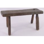 A rustic 19th century elm stool, length 55cm.