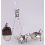 A group of silver and plated items, including silver sauceboat, silver mounted decanter,