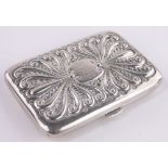 A late Victorian silver note case, relief embossed scroll covers with leather fitted interior,