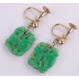 A pair of Chinese carved and pierced jade panel drop earrings, unmarked gold settings,