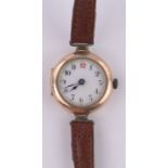 A Victorian lady's gold cased wristwatch, gilded enamel dial, case width 26mm.