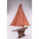 A large Gamages wooden hulled Vintage pond yacht, with sails and rigging on stand,