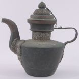 A 19th century Tibetan copper teapot, with relief embossed brass mounts, overall height 27cm.