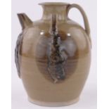 A Chinese brown glaze ceramic teapot, relief embossed figure decoration, height 17cm.